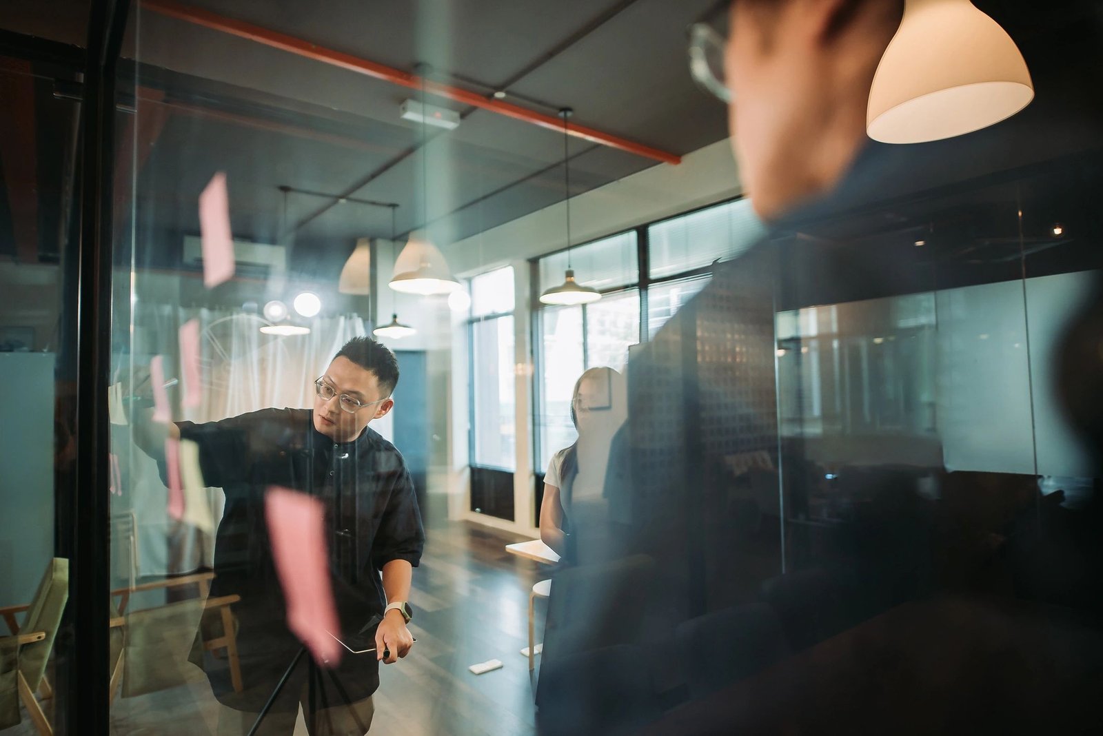 Team brainstorming with sticky notes in a studio