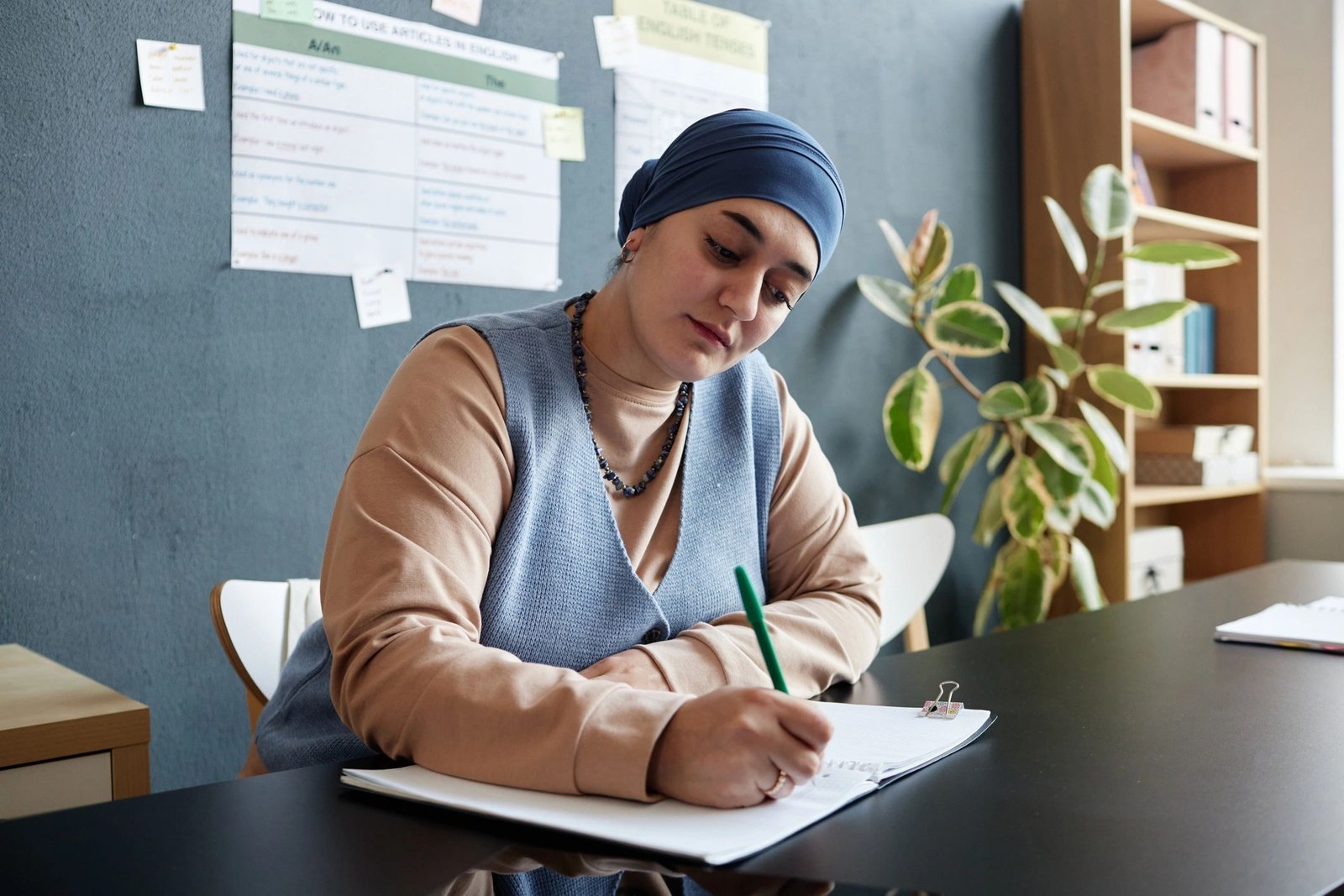 Student writing during an English language class