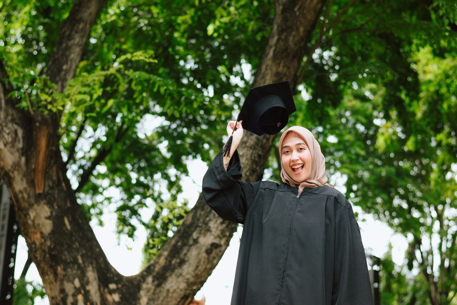 Graduate smiling in a cap and gown