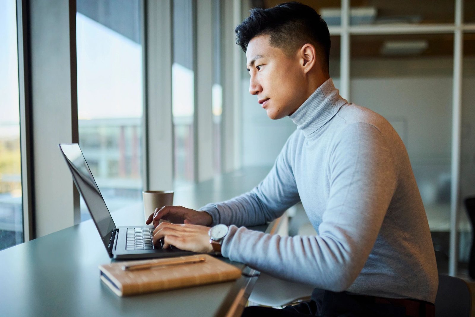 Professional working on a laptop in a modern office